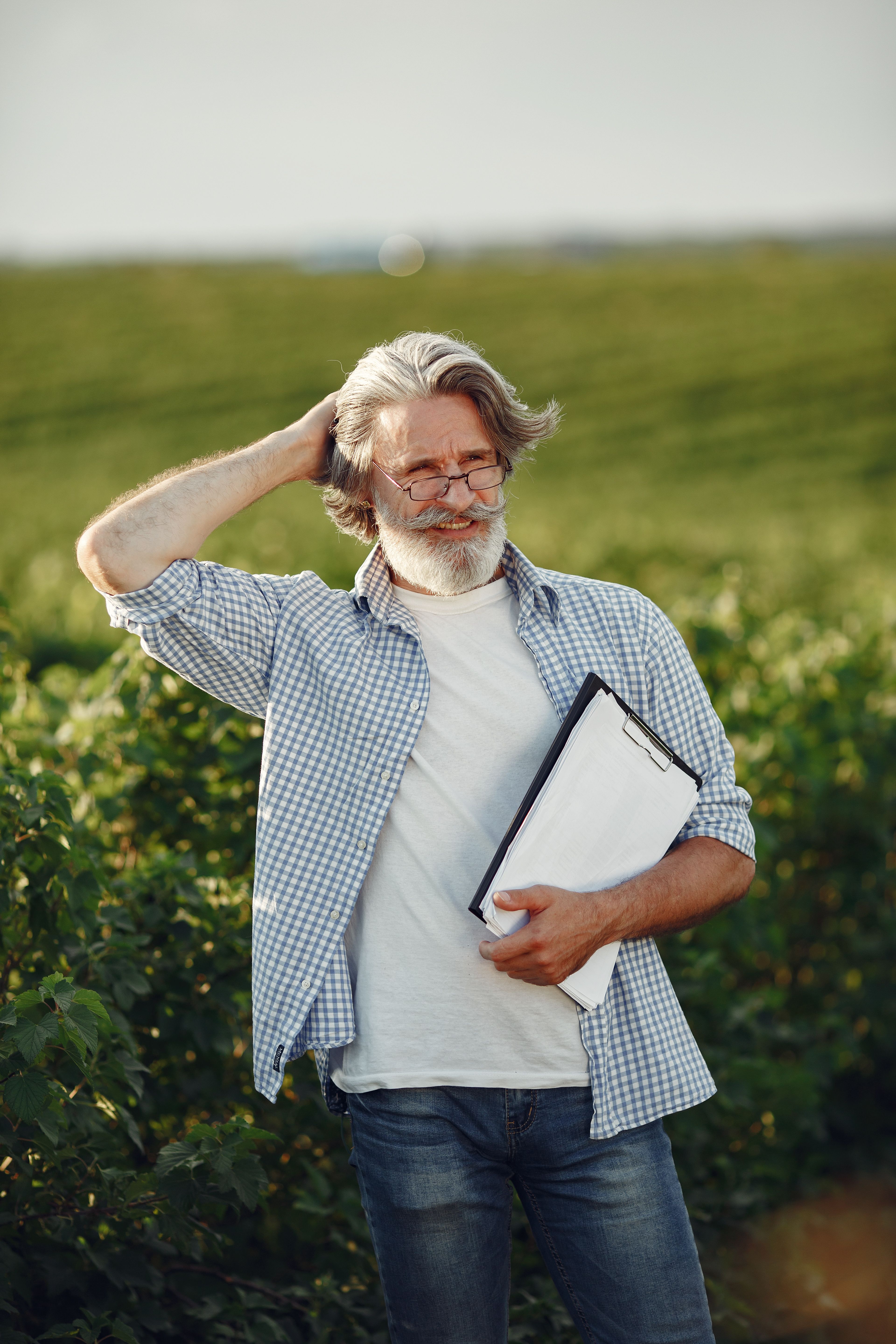 Farmer standing in a lush green wheat field