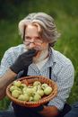 Man in Blue and White Checked Button Up Shirt Holding Green Apple Fruit