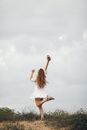 Woman in White Dress Standing on Green Grass Field