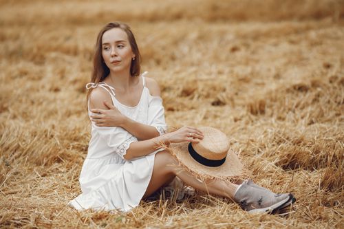 A Woman in White Dress Holding Oat Grass · Free Stock Photo