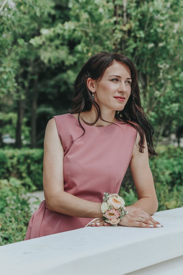 Smiling woman in dress near fence
