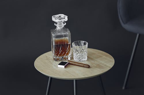 Free Clear Glass Bottle on Brown Wooden Table Stock Photo