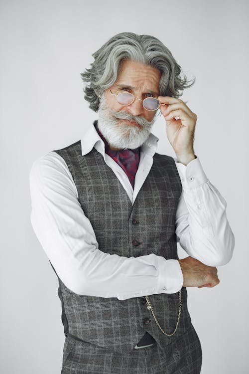 A Man with Gray Hair Wearing Plaid Vest and White Long Sleeves