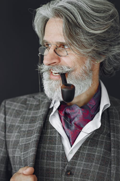 A Man in Suit with Tabaco Pipe in His Mouth