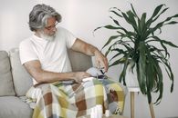 Man in White Crew Neck T-shirt Sitting on Chair