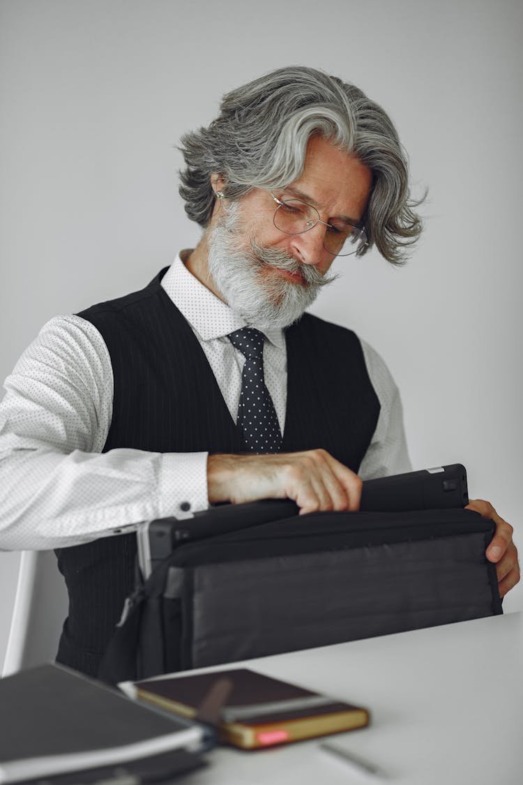 Man Putting Cellphone In Bag