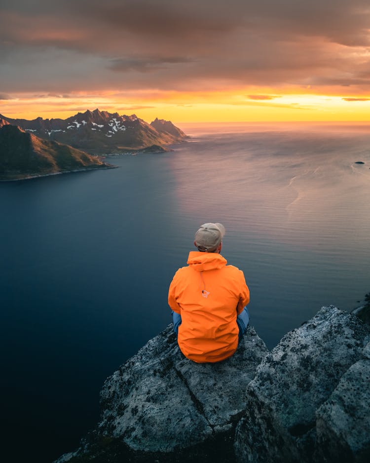 Back View Of A Person Sitting By The Seaside