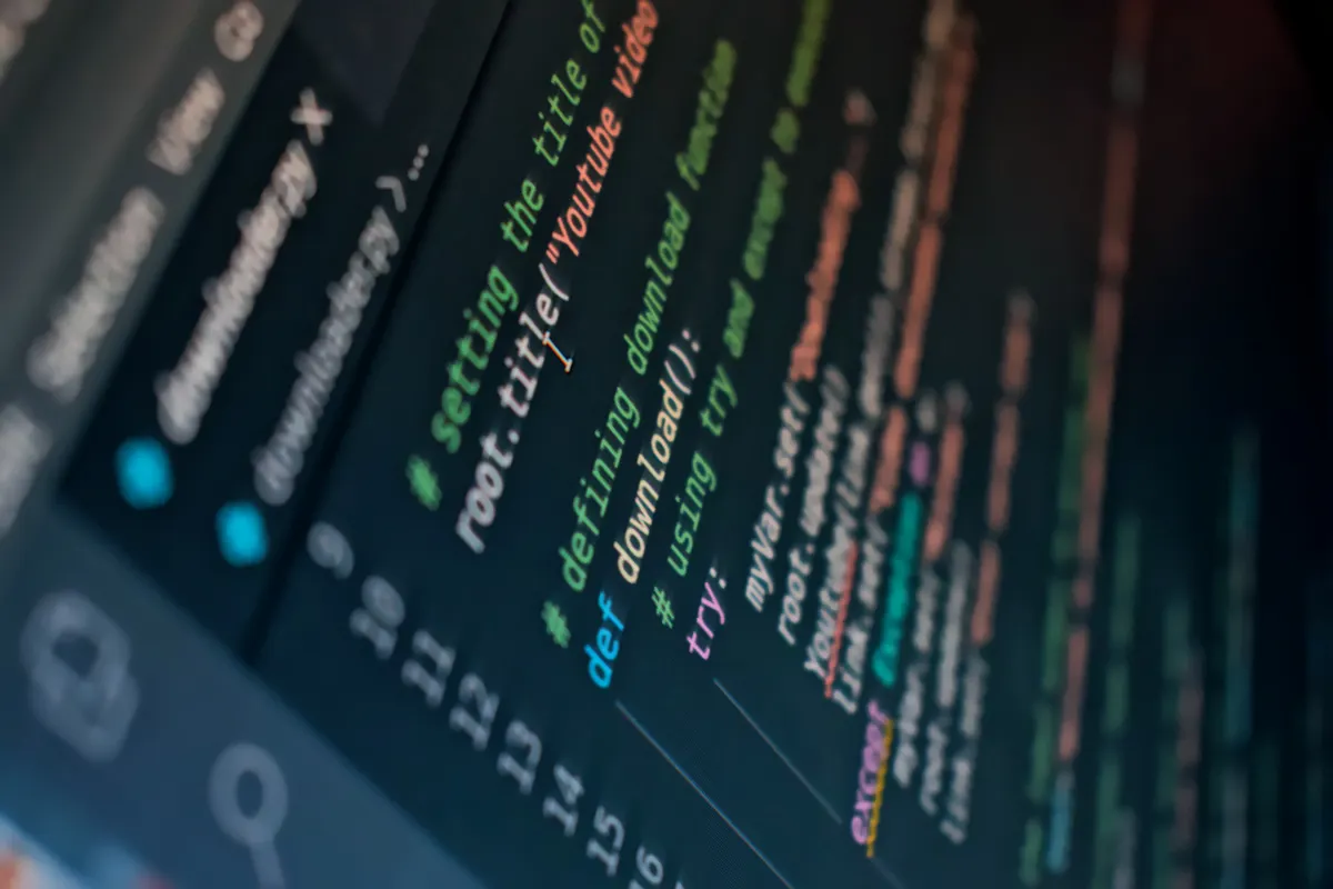 Close-up of a code editor showing syntax-highlighted lines with inline comments on a dark background.