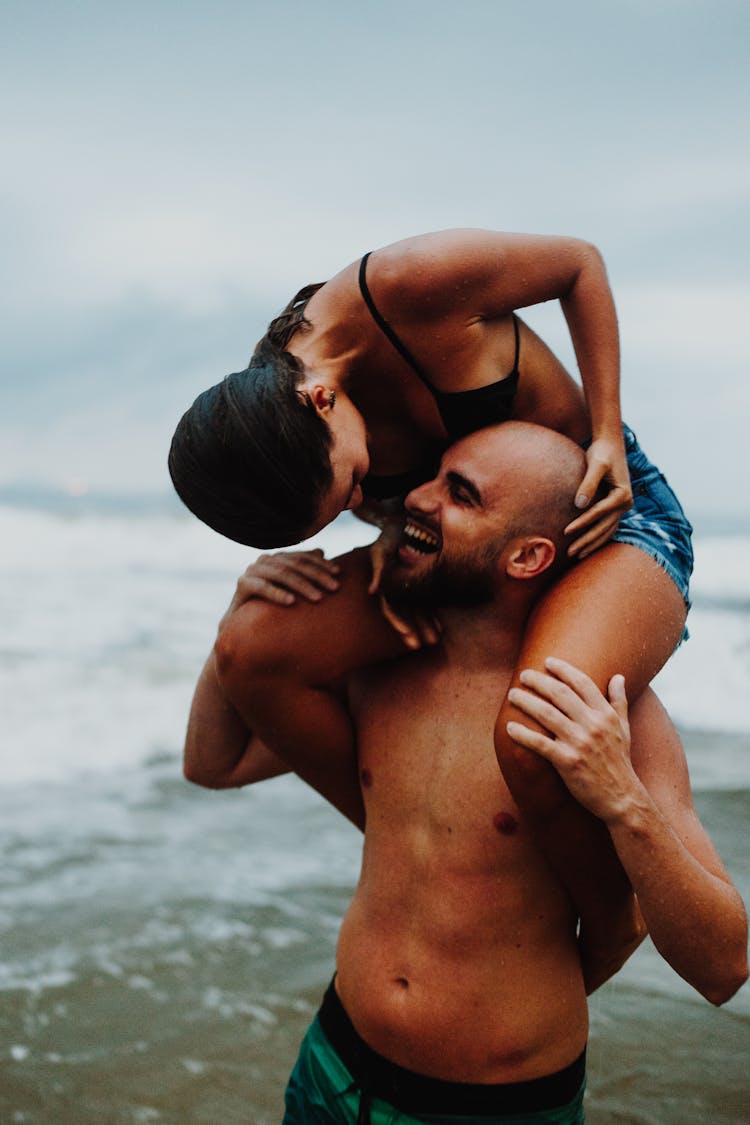  A Woman Riding Piggyback On A Happy Man