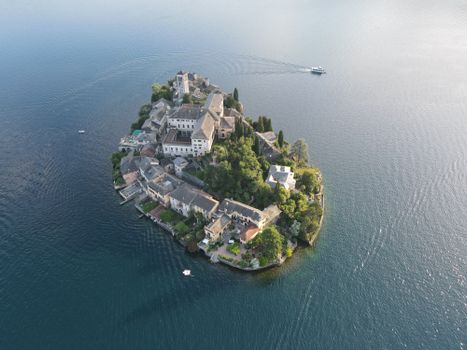 Stunning aerial shot of Isola San Giulio in Lake Orta, Italy, surrounded by peaceful water.