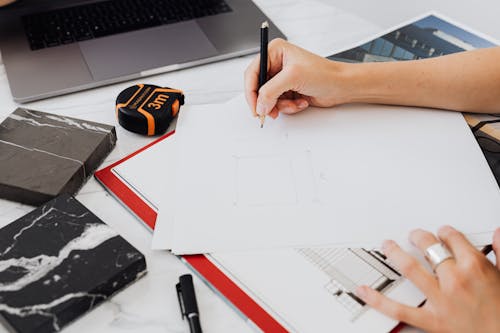 Close-up of Person Making Blueprint on Paper