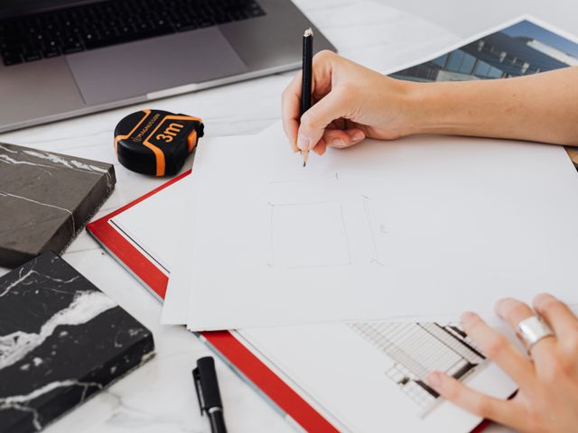 Designer sketching campaign layout at studio desk