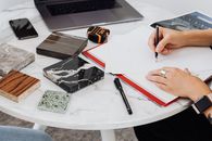 Person Writing on White Paper