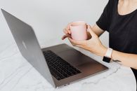 Person in Black Shirt Holding White Ceramic Mug