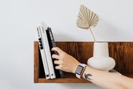 Person Wearing Black and Silver Apple Watch Reading at 10 00