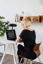 Blonde Woman with Laptop on Desk