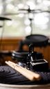 Drumsticks and tuner on drum