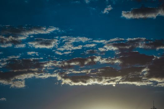 From below of bright blue sky with colorful stratocumulus clouds in sunny day