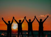 Silhouette of People Standing on Beach during Sunset