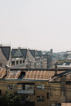 A panoramic view of historic urban rooftops under a clear summer sky in an old district. — photo by cottonbro studio