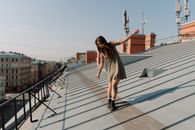 Woman in Black and White Stripe Mini Dress Standing on Gray Concrete Floor