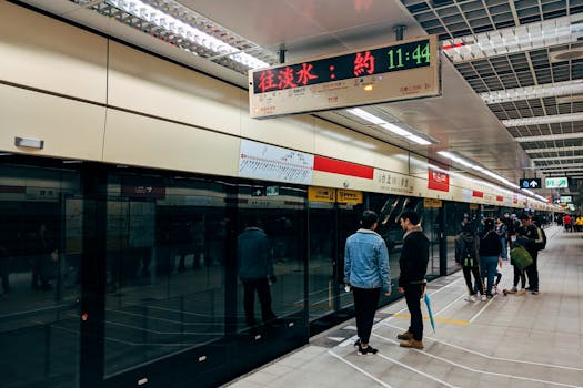 A busy day at Taipei Metro station with commuters waiting on the platform.