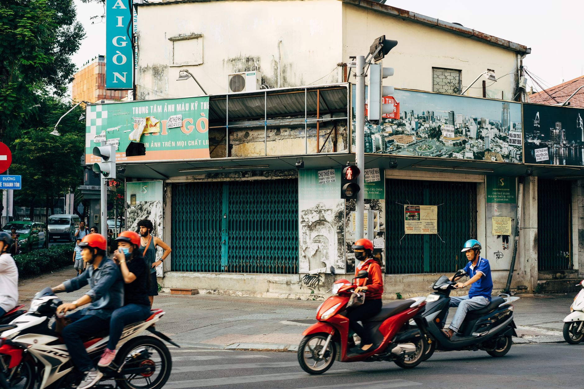 Motorcyclists navigate a vibrant street in Ho Chi Minh City, showcasing urban life and culture.
