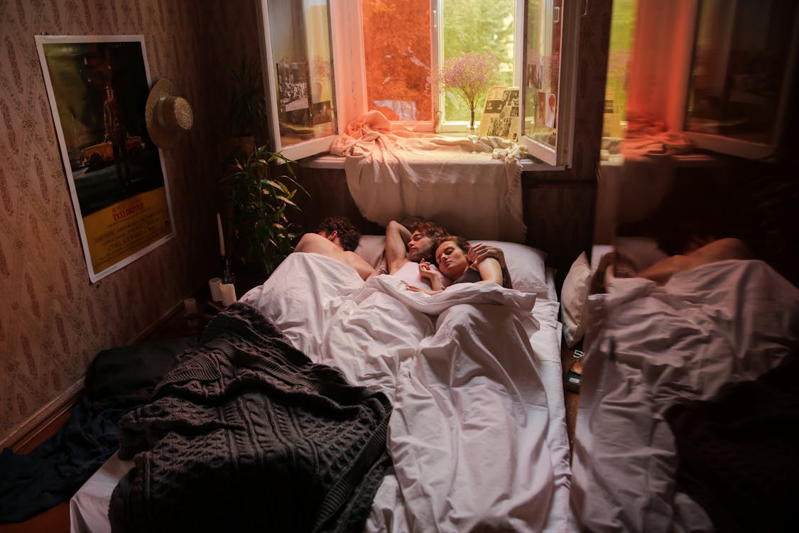 Free Woman in White Shirt Lying on Bed Stock Photo