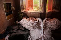 Woman in White Shirt Lying on Bed