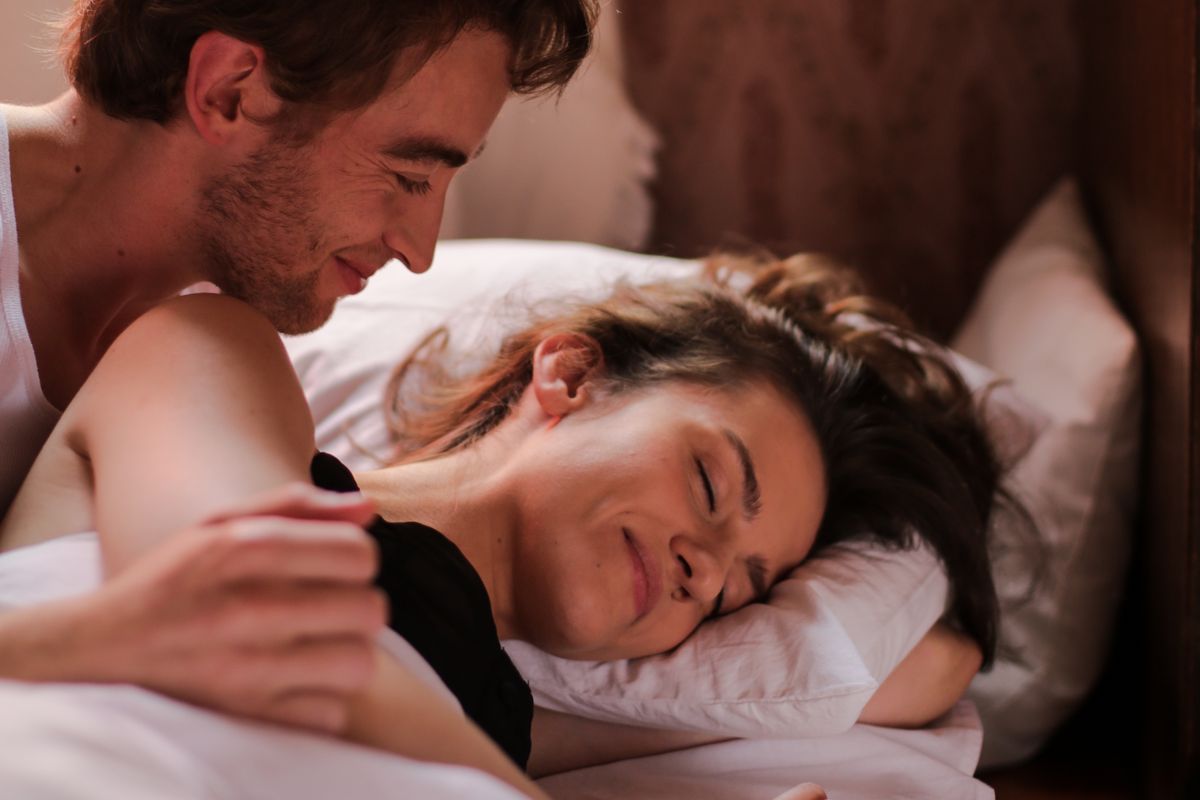 A couple asleep in bed at night