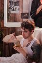 Man in White Tank Top Holding Clear Drinking Glass