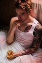 Woman in White Tank Top Sitting on Bed