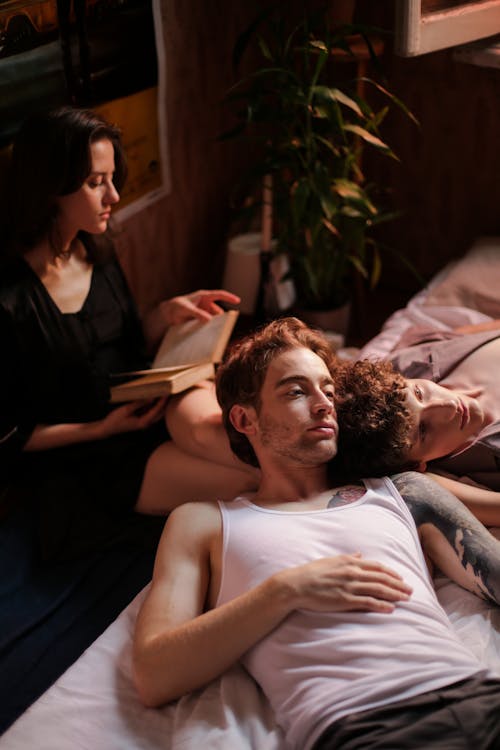 Man in Black Shirt Lying on Bed