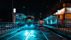 People Standing Near Red Train during Night Time