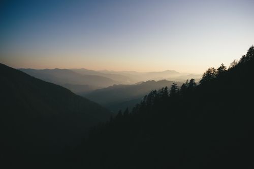 Free Stunning view of mountain silhouettes at sunrise, showcasing nature's tranquility and beauty. Stock Photo