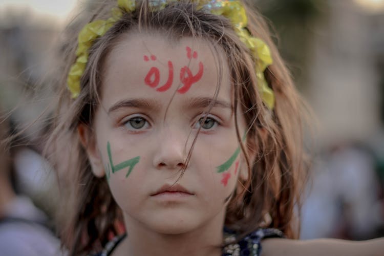 Emotionless Girl With Arabic Script On Forehead