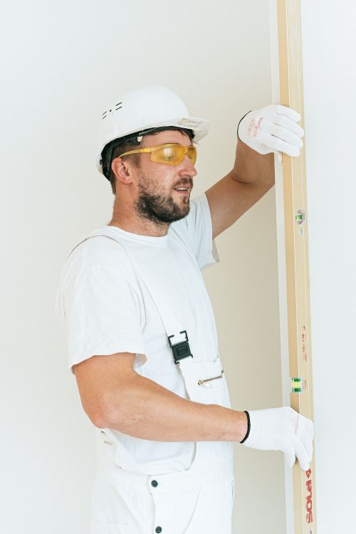 A Man Holding a Level Bar · Free Stock Photo