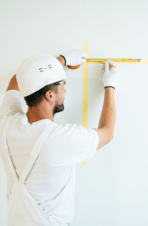 Man in White Chef Uniform Holding White Ruler