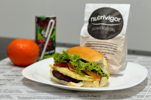 Close-up of a Sandwich, Tangerine and Juice in a Box 