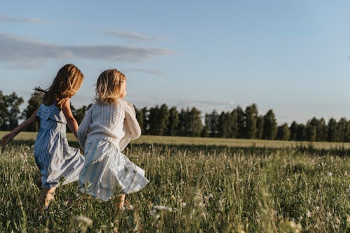 Girls Running on Green Grass Field