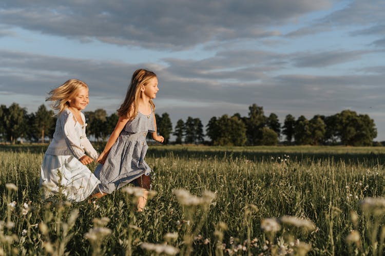 A Two Young Girl Running Together