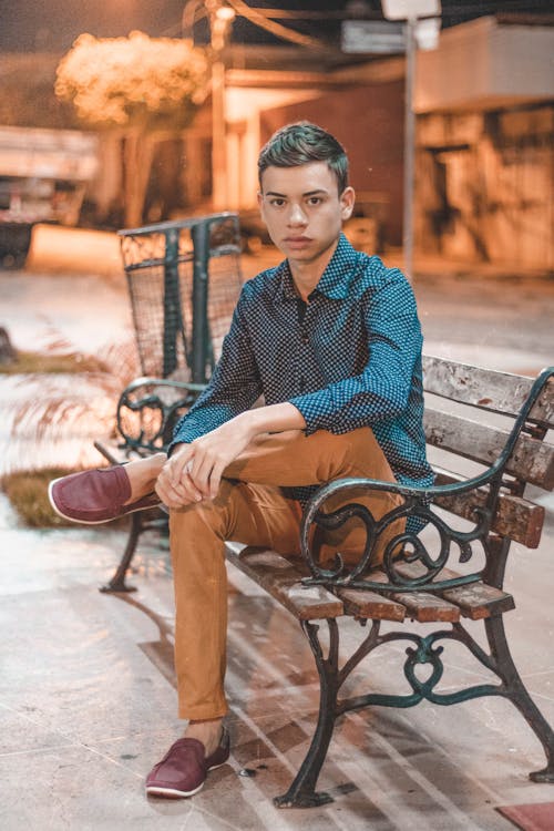 Fashion Teenage Boy Sitting on Bench in Street