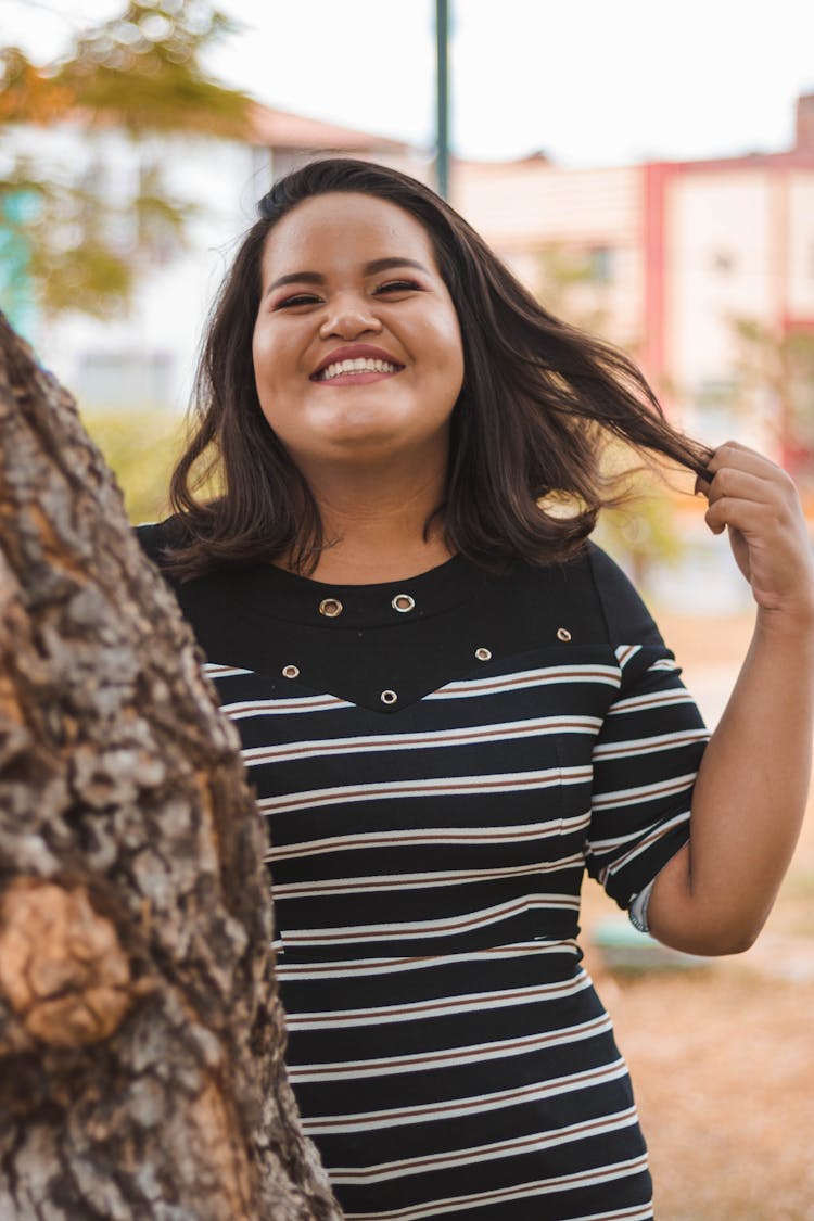 Smiling Woman Playing With Her Hair