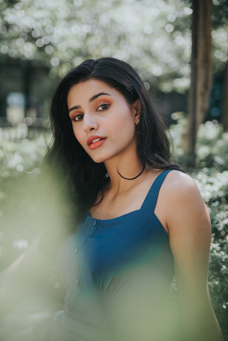 Stylish Ethnic Woman With Makeup In Garden