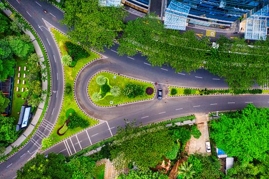 Aerial view showcasing a vibrant road junction amidst greenery in Jakarta, Indonesia.