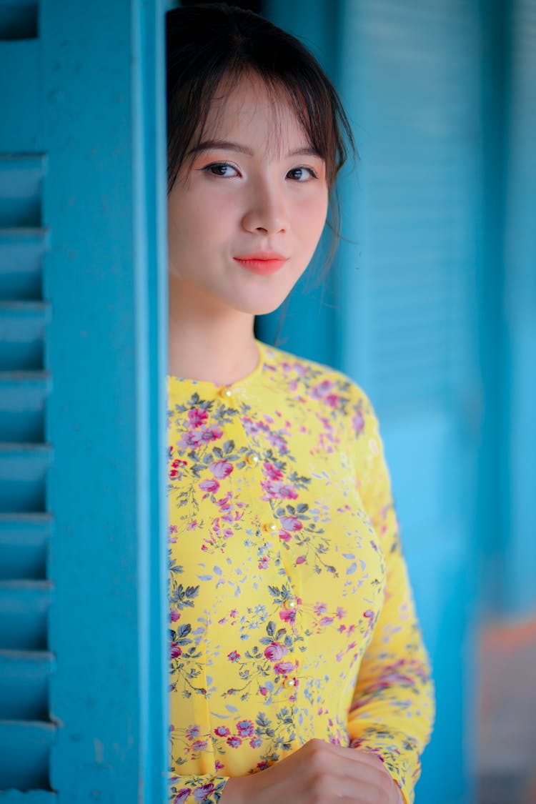 Charming Asian Woman Standing Near Wooden Door