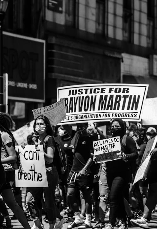 Black and white of people walking on street demonstration for police brutality and black lives matter