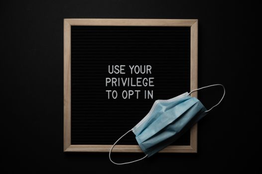 Chalkboard with BLM title near face mask during quarantine period
