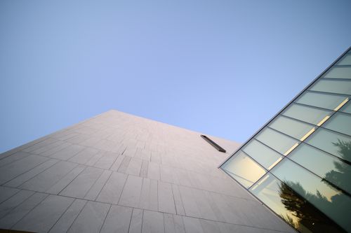 Free From below of contemporary multistage house facade with ornamental walls under blue sky Stock Photo