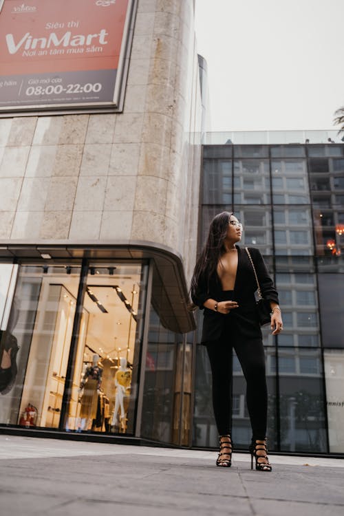 Woman in Suit Standing on Pavement